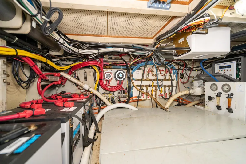 Slide: The Image of Engine room of a 1966 Willard Marine 47, showcasing wiring and control panels. - 94