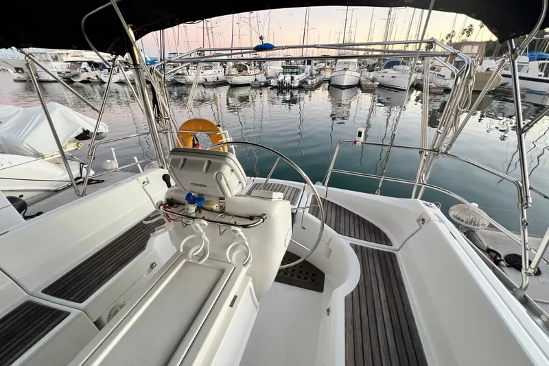 Slide: The Image of Cockpit view of 1993 Beneteau Oceanis 440 sailboat docked in a marina. - 13