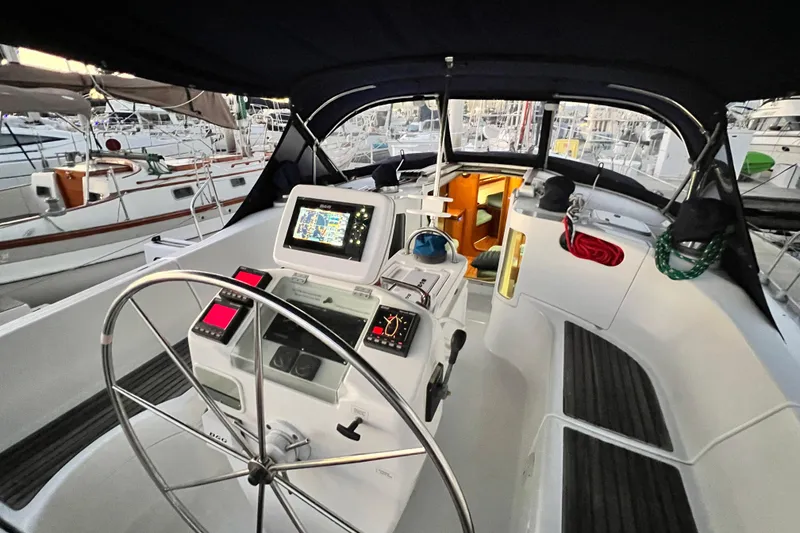 Slide: The Image of Cockpit of 1993 Beneteau Oceanis 440 sailboat with navigation equipment and steering wheel. - 19