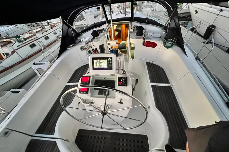 Slide: The Image of Cockpit of 1993 Beneteau Oceanis 440 sailboat with navigation equipment and steering wheel. - 20