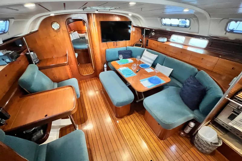 Slide: The Image of Interior of 1993 Beneteau Oceanis 440 yacht with cozy seating and dining area. - 22