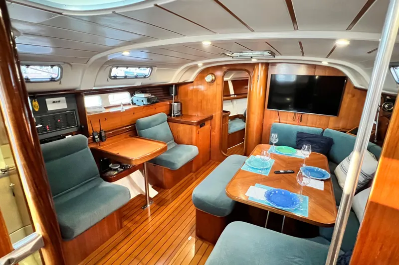 Slide: The Image of Interior of 1993 Beneteau Oceanis 440 yacht with cozy seating and dining area. - 23