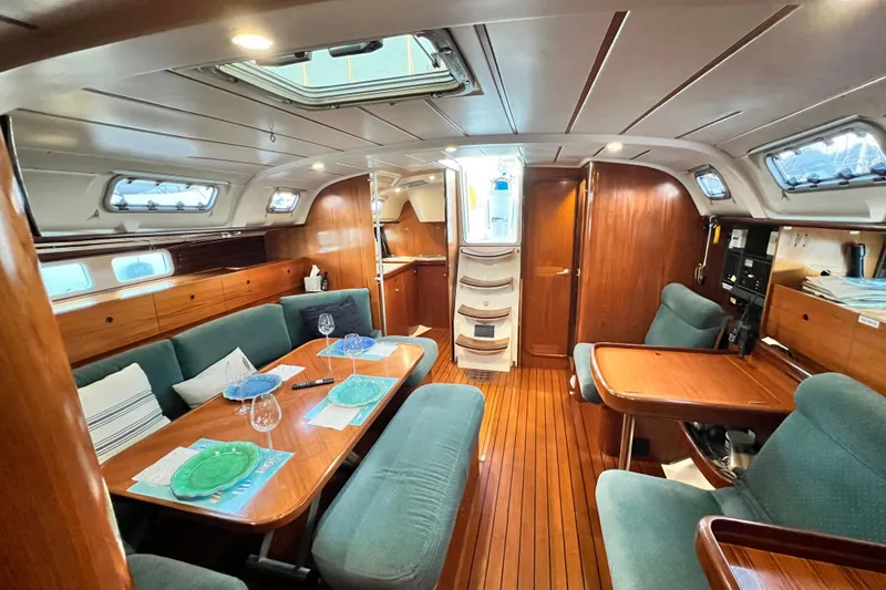 Slide: The Image of Interior of 1993 Beneteau Oceanis 440 yacht with elegant wood finish and cozy seating. - 24