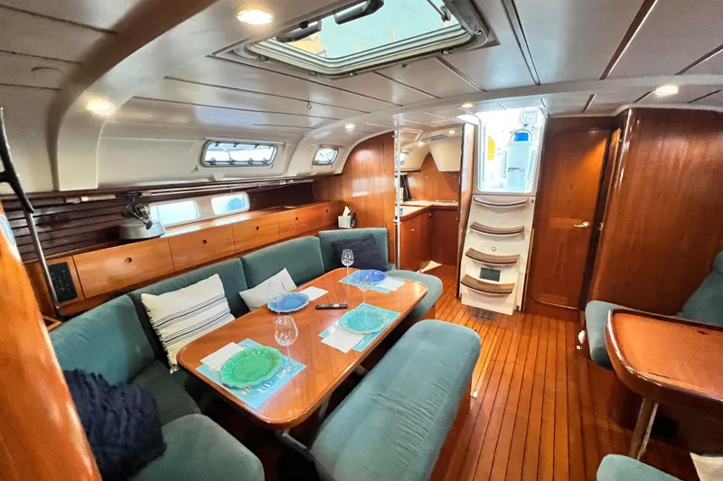 Slide: The Image of Interior of 1993 Beneteau Oceanis 440 yacht with elegant wood finish and cozy seating. - 27