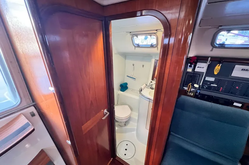 Slide: The Image of Interior of 1993 Beneteau Oceanis 440 yacht showing bathroom and control panel. - 35