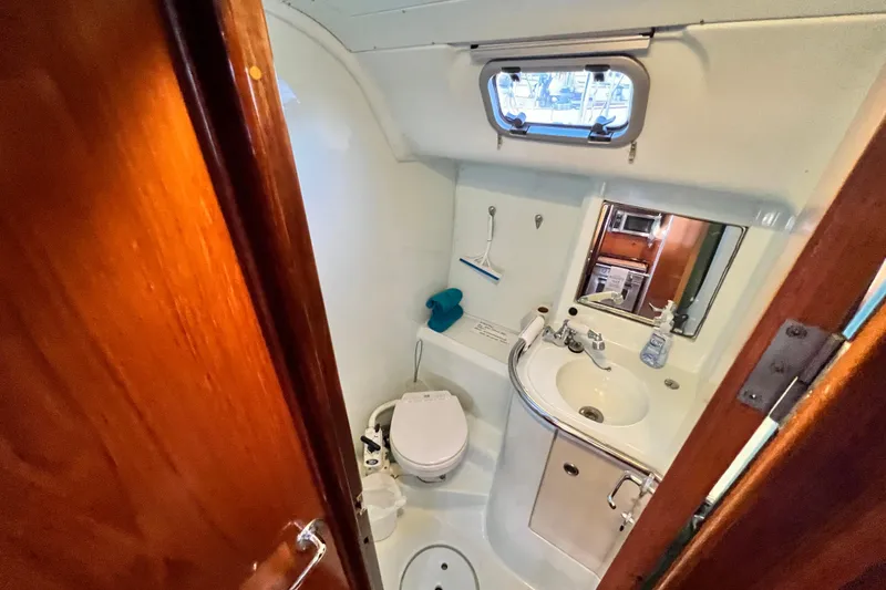 Slide: The Image of Bathroom interior of 1993 Beneteau Oceanis 440 yacht, featuring sink and toilet. - 36