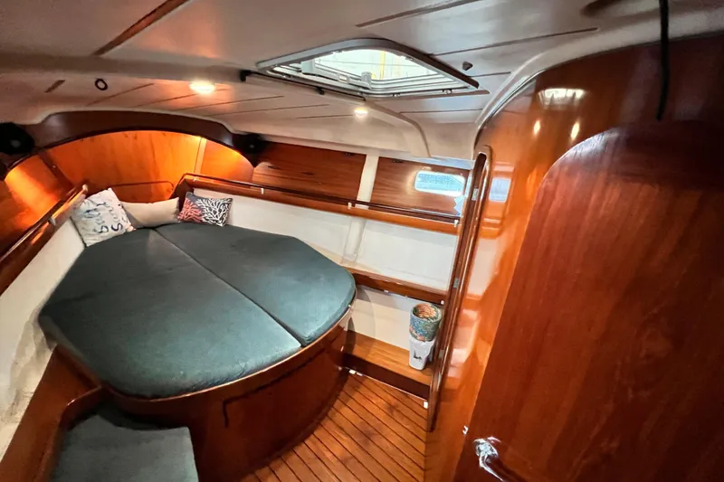 Slide: The Image of Cozy cabin interior of 1993 Beneteau Oceanis 440 sailboat with wooden finish and cushions. - 38