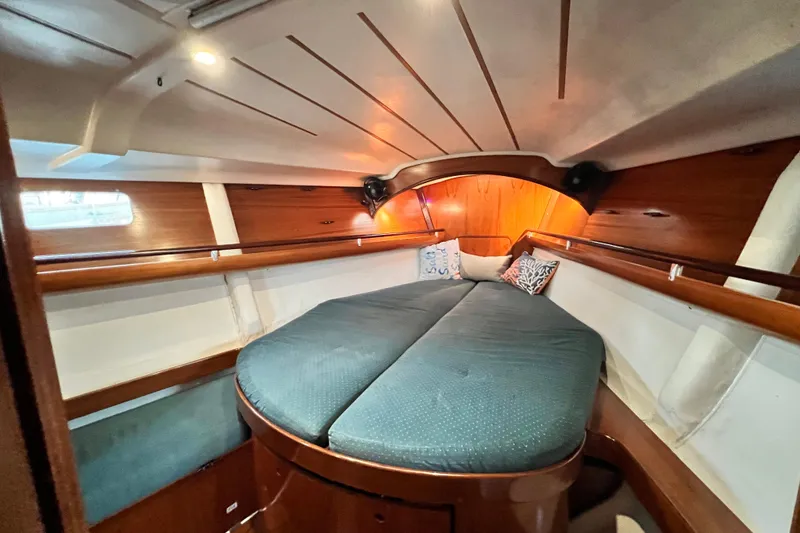 Slide: The Image of Cozy cabin interior of 1993 Beneteau Oceanis 440 sailboat with wooden accents and cushions. - 39