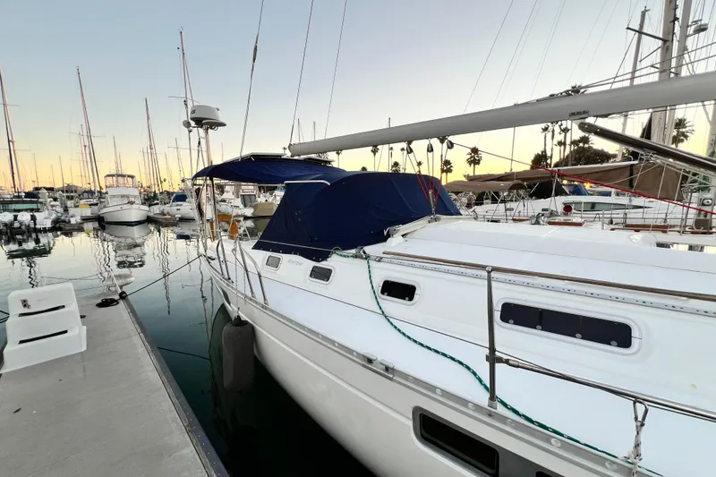 Slide: The Image of 1993 Beneteau Oceanis 440 sailboat docked at marina during sunset. - 4