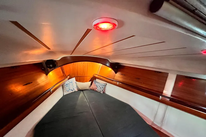 Slide: The Image of Cozy cabin interior of 1993 Beneteau Oceanis 440 sailboat with warm lighting. - 40