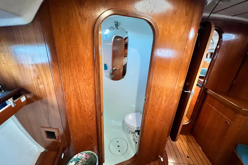 Slide: The Image of Interior of 1993 Beneteau Oceanis 440 yacht showing wooden cabin and compact bathroom. - 42