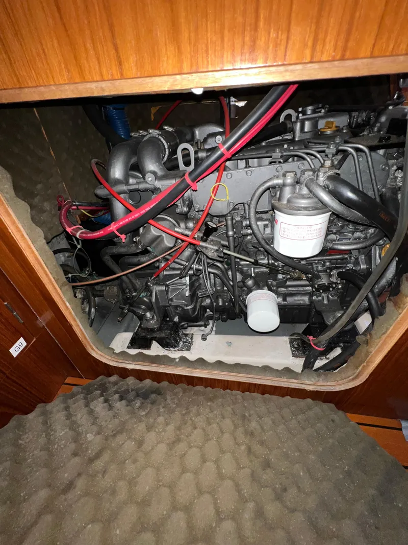 Slide: The Image of Engine compartment of a 1993 Beneteau Oceanis 440 sailboat, showcasing wiring and components. - 49