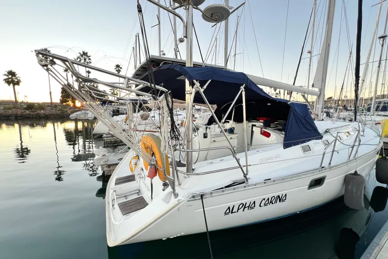 Slide: The Image of 1993 Beneteau Oceanis 440 sailboat docked at marina during sunset. - 5