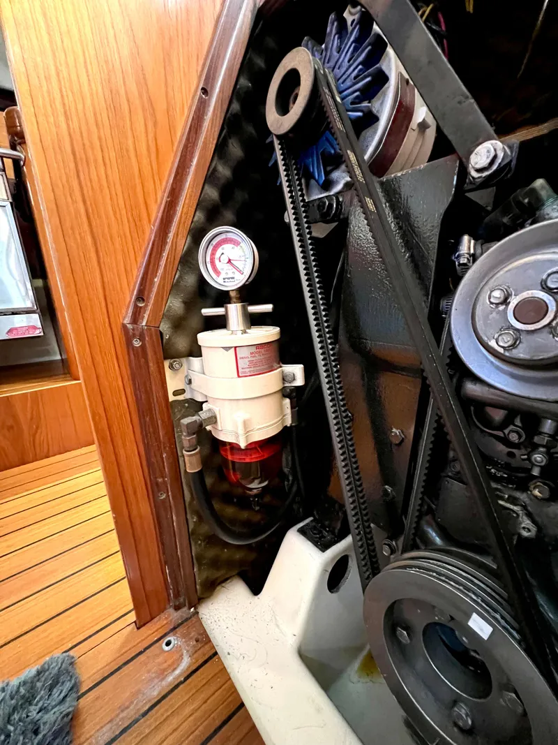 Slide: The Image of Engine compartment of a 1993 Beneteau Oceanis 440 sailboat, showcasing mechanical components. - 50
