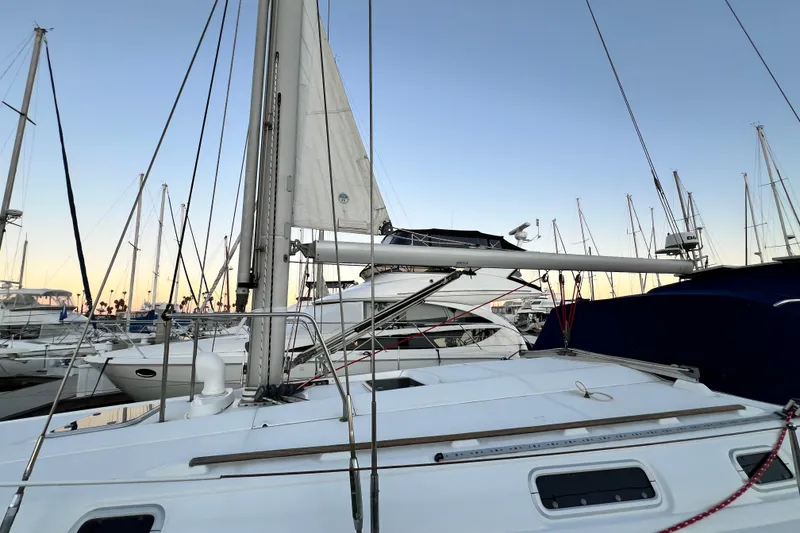 Slide: The Image of Sailboat Beneteau Oceanis 440, 1993 model, docked at marina during sunset. - 8