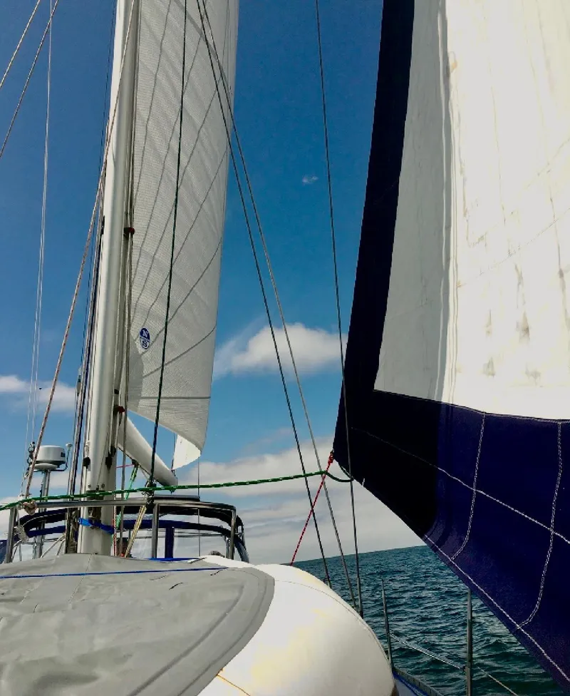 Slide: The Image of Sailing on a 1993 Beneteau Oceanis 440 under clear blue skies. - 9