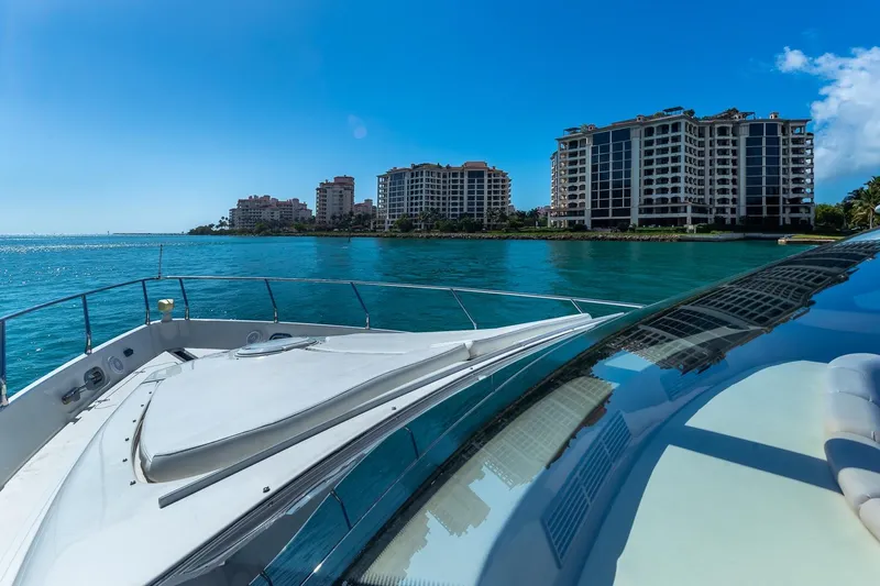 Slide: The Image of Luxury yacht cruising near waterfront buildings under clear blue sky. - 11