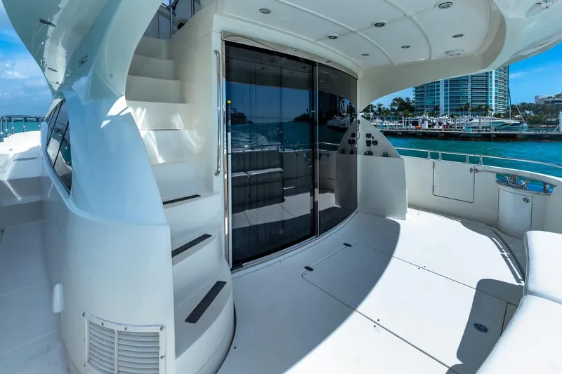Slide: The Image of Luxurious 2005 Marquis 59 yacht deck with stairs and waterfront view. - 14
