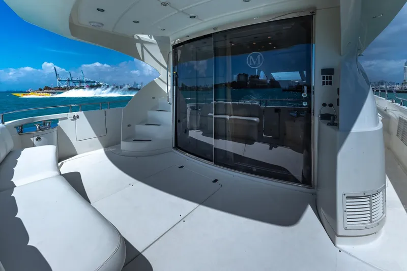 Slide: The Image of Luxurious 2005 Marquis 59 yacht deck with ocean view and speedboat in background. - 15
