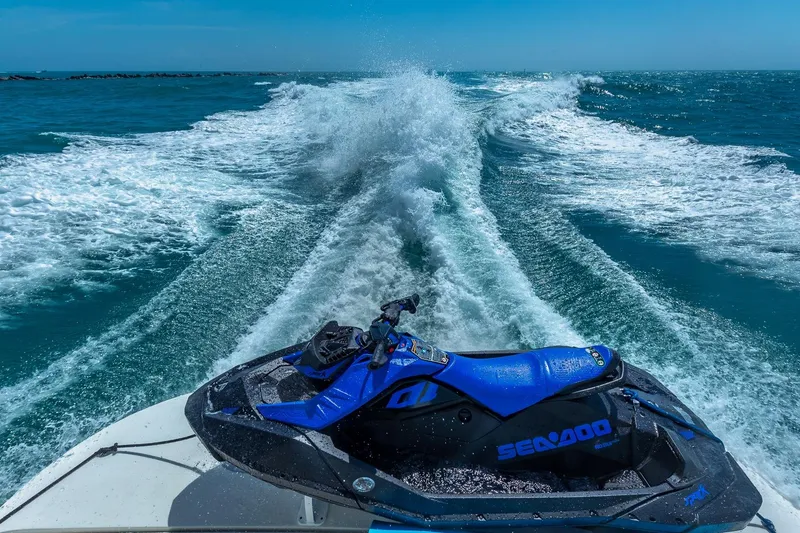 Slide: The Image of Jet ski on a 2005 Marquis 59 yacht, cruising through ocean waves. - 24