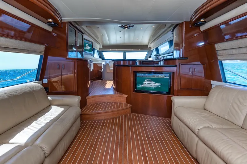 Slide: The Image of Luxurious interior of a 2005 Marquis 59 yacht with leather seating and wood finishes. - 25