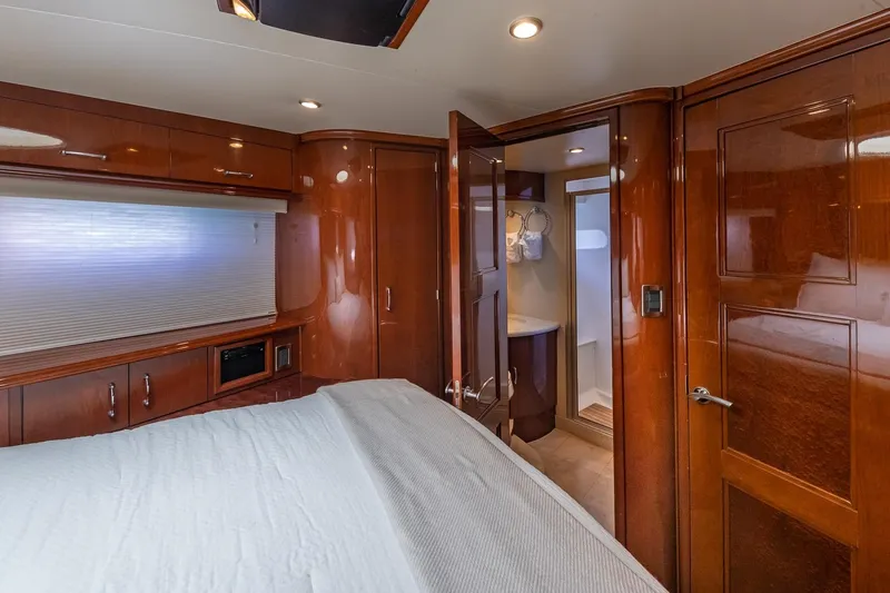 Slide: The Image of Luxurious 2005 Marquis 59 yacht interior with wood paneling and ensuite bathroom. - 28