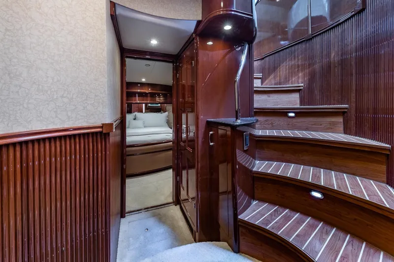 Slide: The Image of Luxurious interior of a 2005 Marquis 59 yacht with elegant wooden staircase and cozy bedroom. - 36