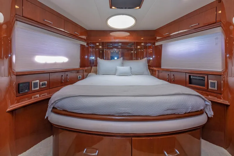 Slide: The Image of Luxurious 2005 Marquis 59 yacht bedroom with elegant wood finish and cozy bedding. - 37