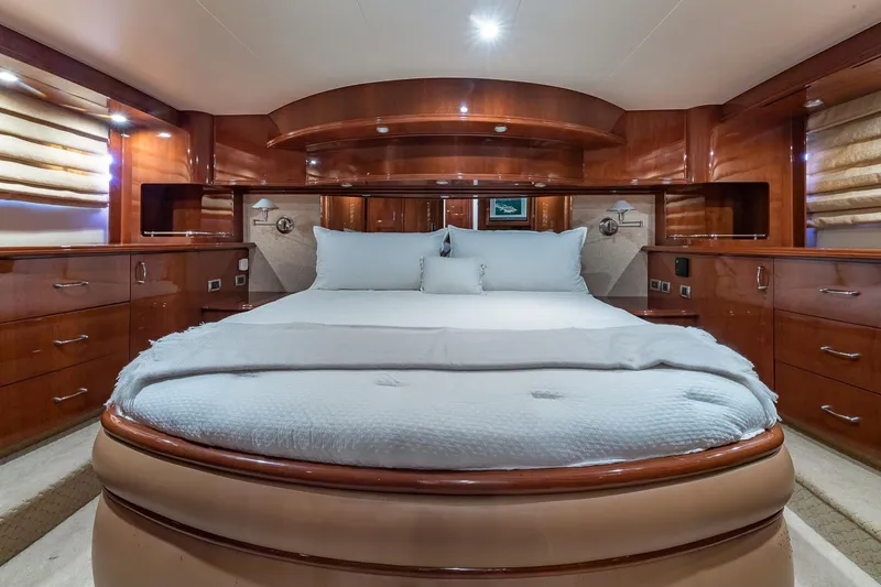 Slide: The Image of Luxurious 2005 Marquis 59 yacht bedroom with elegant wood finishes and plush bedding. - 38