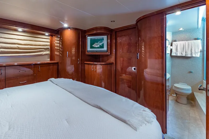 Slide: The Image of Luxurious 2005 Marquis 59 yacht bedroom with ensuite bathroom, featuring elegant wood finishes. - 39