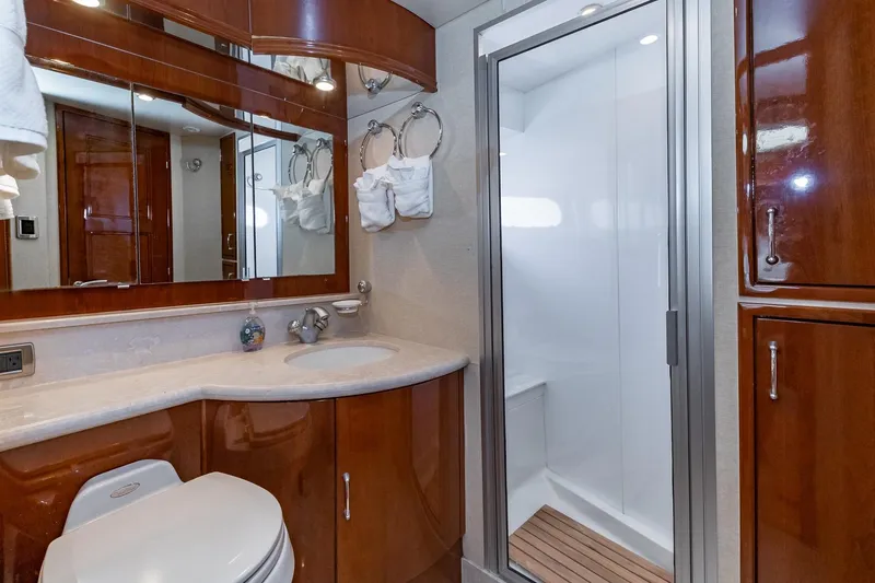 Slide: The Image of Luxurious 2005 Marquis 59 yacht bathroom with wood cabinetry and modern shower. - 40