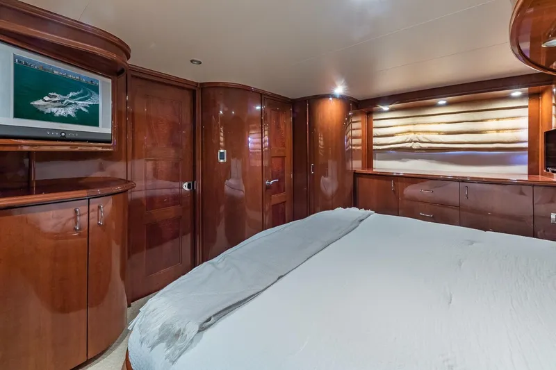 Slide: The Image of Luxurious 2005 Marquis 59 yacht bedroom with wood paneling and TV. - 41