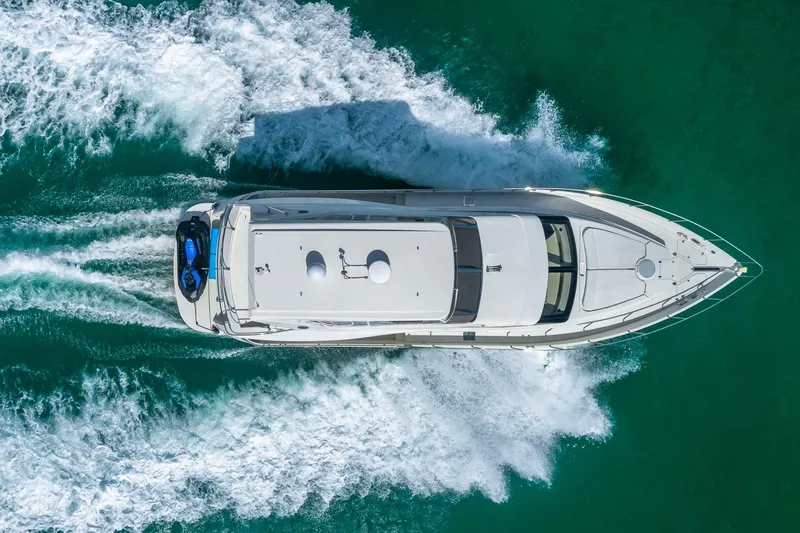 Slide: The Image of Aerial view of 2005 Marquis 59 yacht cruising on turquoise water. - 8