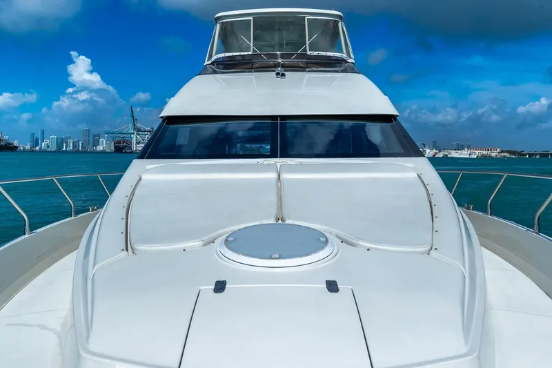 Slide: The Image of Luxury 2005 Marquis 59 yacht on blue ocean with city skyline in background. - 9