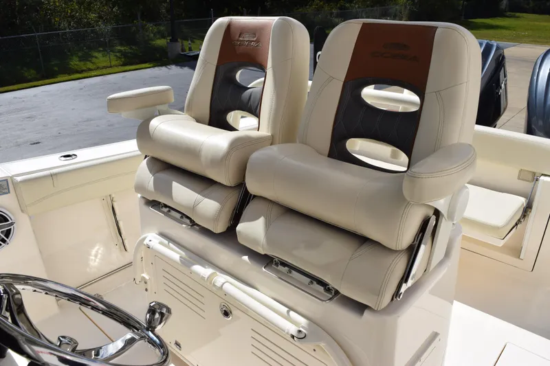 Slide: The Image of 2022 Cobia 280 Center Console boat seats with luxurious beige upholstery and armrests. - 12