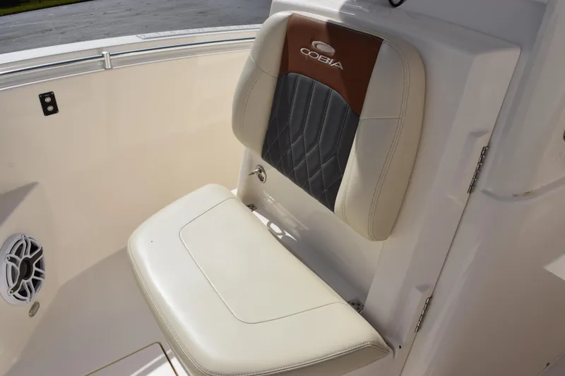 Slide: The Image of 2022 Cobia 280 Center Console boat seat with stylish upholstery and speaker detail. - 14