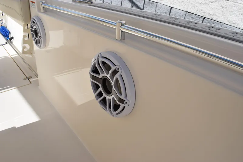 Slide: The Image of 2022 Cobia 280 Center Console boat with mounted speakers and stainless steel railing. - 15