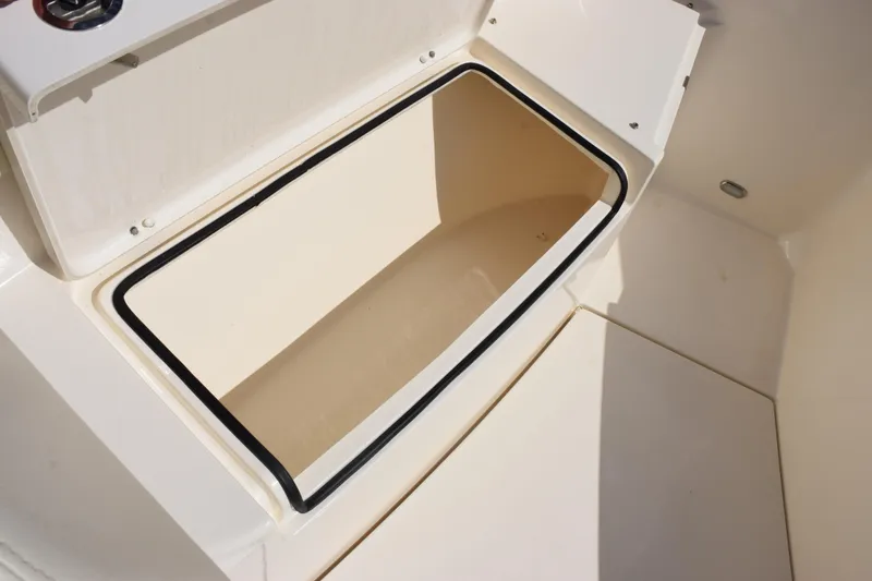 Slide: The Image of Storage compartment on 2022 Cobia 280 Center Console boat, open and empty. - 17