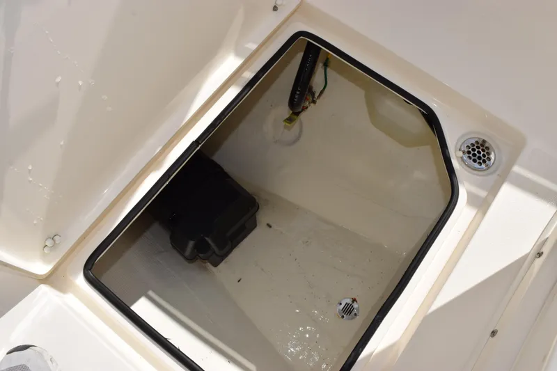 Slide: The Image of 2022 Cobia 280 Center Console storage compartment with drainage and wiring. - 18