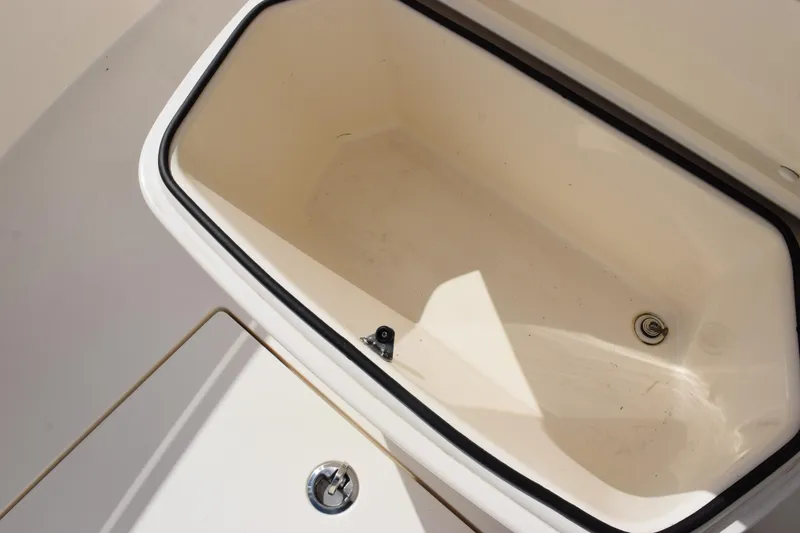 Slide: The Image of Open storage compartment on 2022 Cobia 280 Center Console boat. - 20