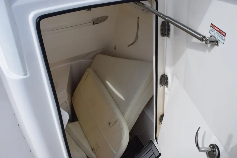 Slide: The Image of 2022 Cobia 280 Center Console storage compartment with cushioned seating. - 21