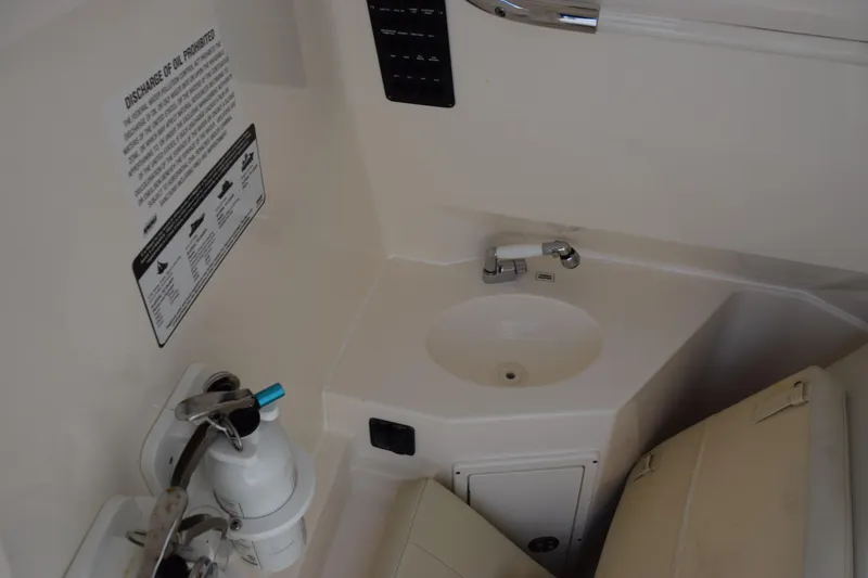 Slide: The Image of 2022 Cobia 280 Center Console boat interior with sink and fire extinguisher. - 22