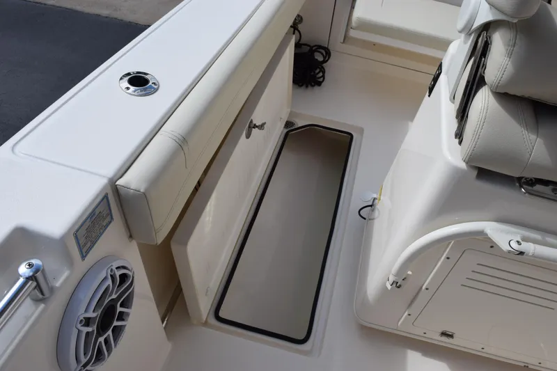 Slide: The Image of 2022 Cobia 280 Center Console boat interior with storage compartment and seating. - 25
