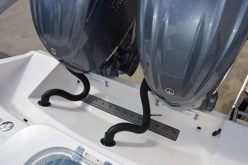 Slide: The Image of 2022 Cobia 280 Center Console with dual Yamaha outboard engines and measurement scale. - 28