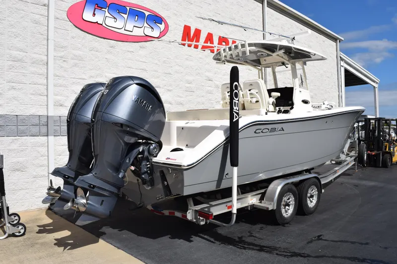 Slide: The Image of 2022 Cobia 280 Center Console boat with dual Yamaha engines on trailer. - 4