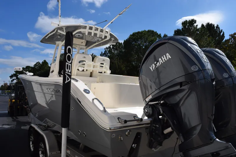 Slide: The Image of 2022 Cobia 280 Center Console boat with Yamaha engines, parked outdoors. - 6