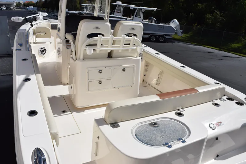 Slide: The Image of 2022 Cobia 280 Center Console boat interior with seating and storage compartments. - 7