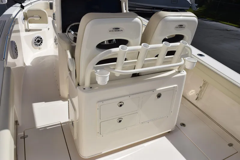 Slide: The Image of 2022 Cobia 280 Center Console boat interior with rod holders and storage compartments. - 8
