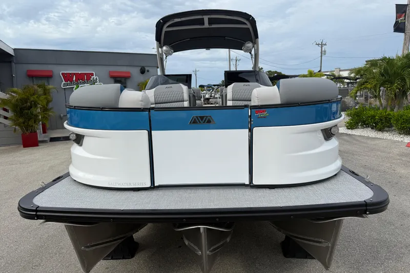 Slide: The Image of 2026 Avalon 2785 Excalibur LTD pontoon boat, blue and white, at dockside view. - 4