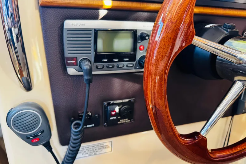 Slide: The Image of 2012 Ranger Tugs R-31 helm with wooden steering wheel and VHF radio. - 12